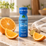 Alfa CollagenC Shot with orange and ginger — bottle close-up on a pale stone counter.