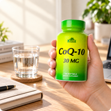 Adult holding Alfa CoQ-10 bottle in a natural desk setting