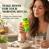 Woman holding Alfa Vitamins Green Tea beside breakfast and water.