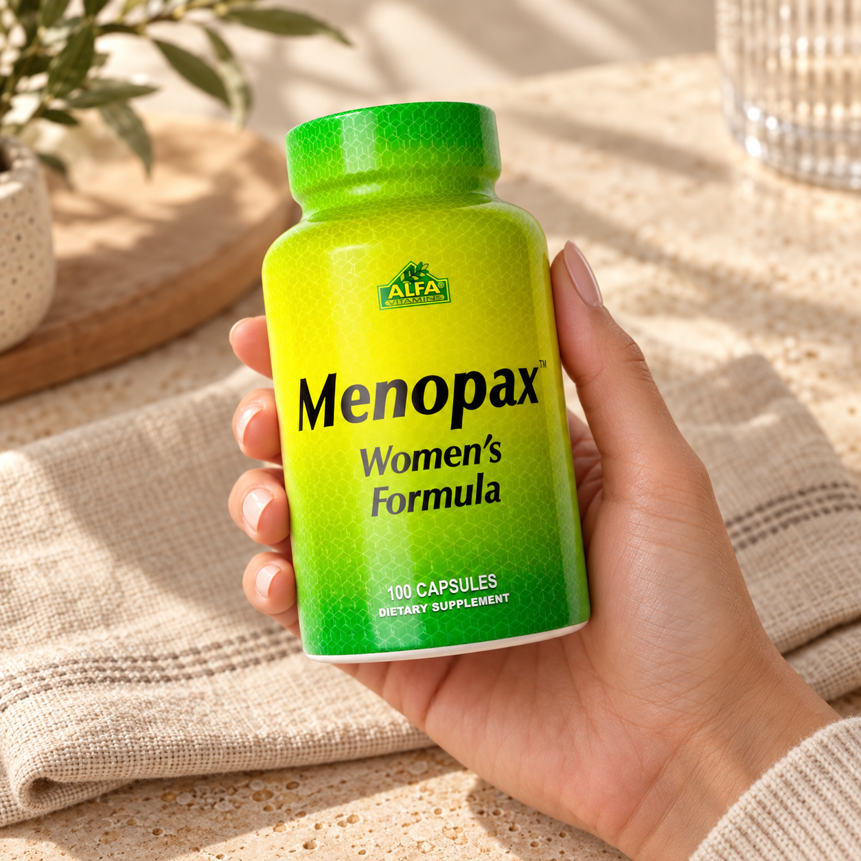 Menopax Women's Formula - 100 capsules: front packaging in an adult hand.