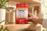 Adult handling a closed Alfa SuperC Immune canister on a pantry shelf.
