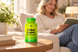 Closed Alfa Vision Support bottle beside an adult reading at home.