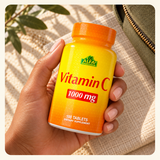 An adult hand holding the Alfa Vitamin C bottle