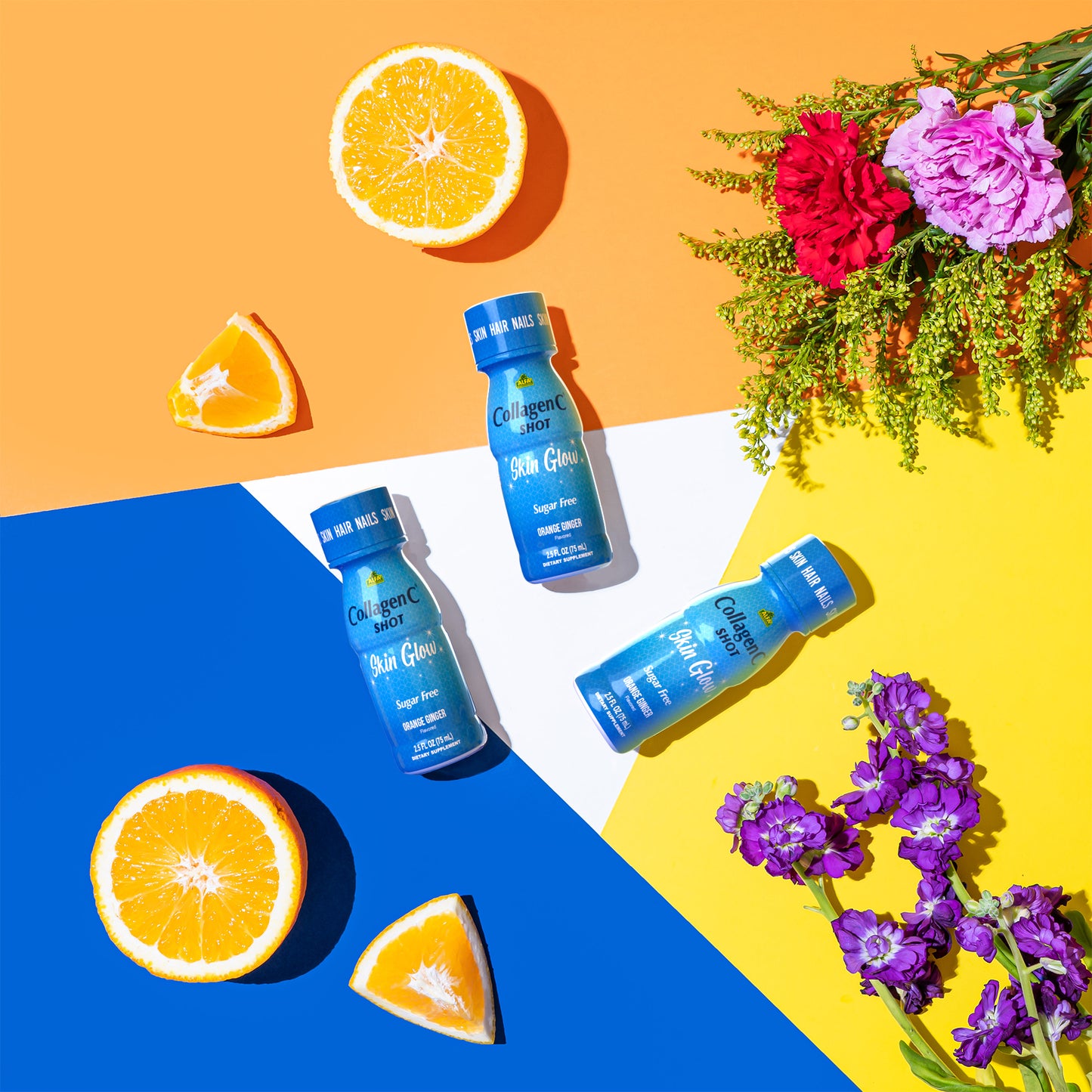 Three CollagenC Shot bottles from Alfa Vitamins Store sit on a vibrant geometric background with sliced oranges and bright flowers like pink carnations and purple stock, blending perfectly with the skin glow promise.